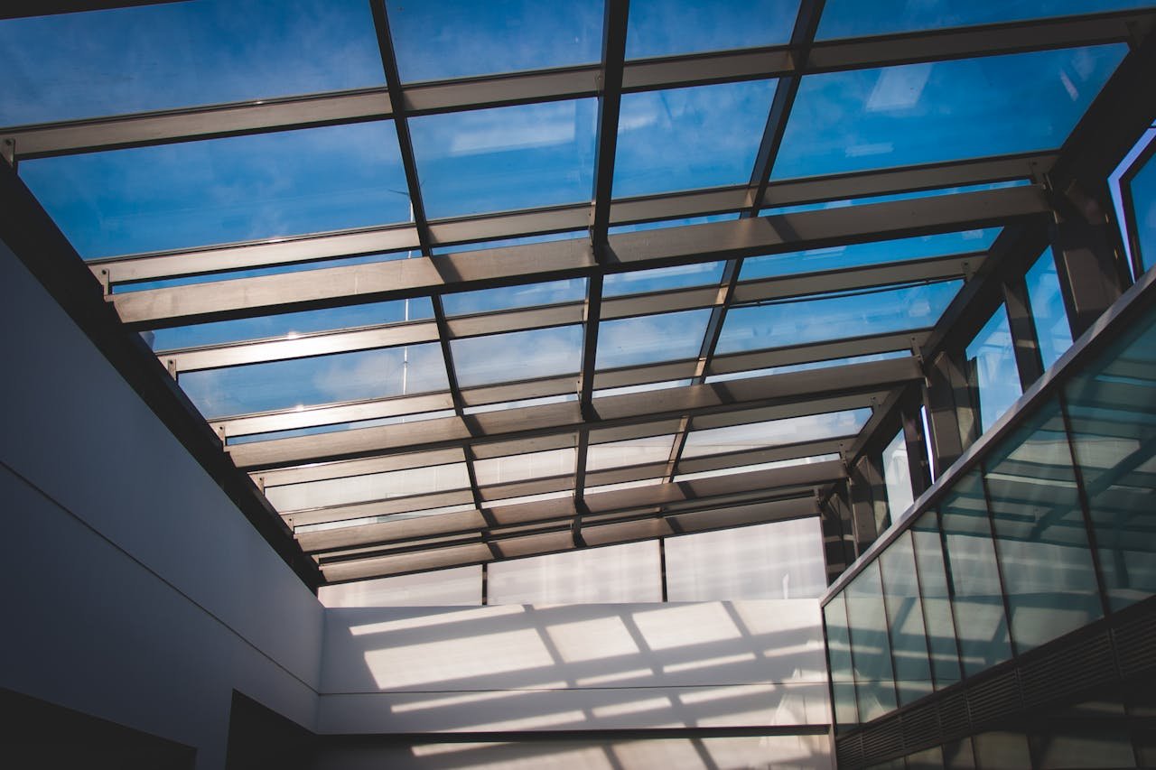 gallery-5 Contemporary architectural design showcasing a glass roof with clear sky view.